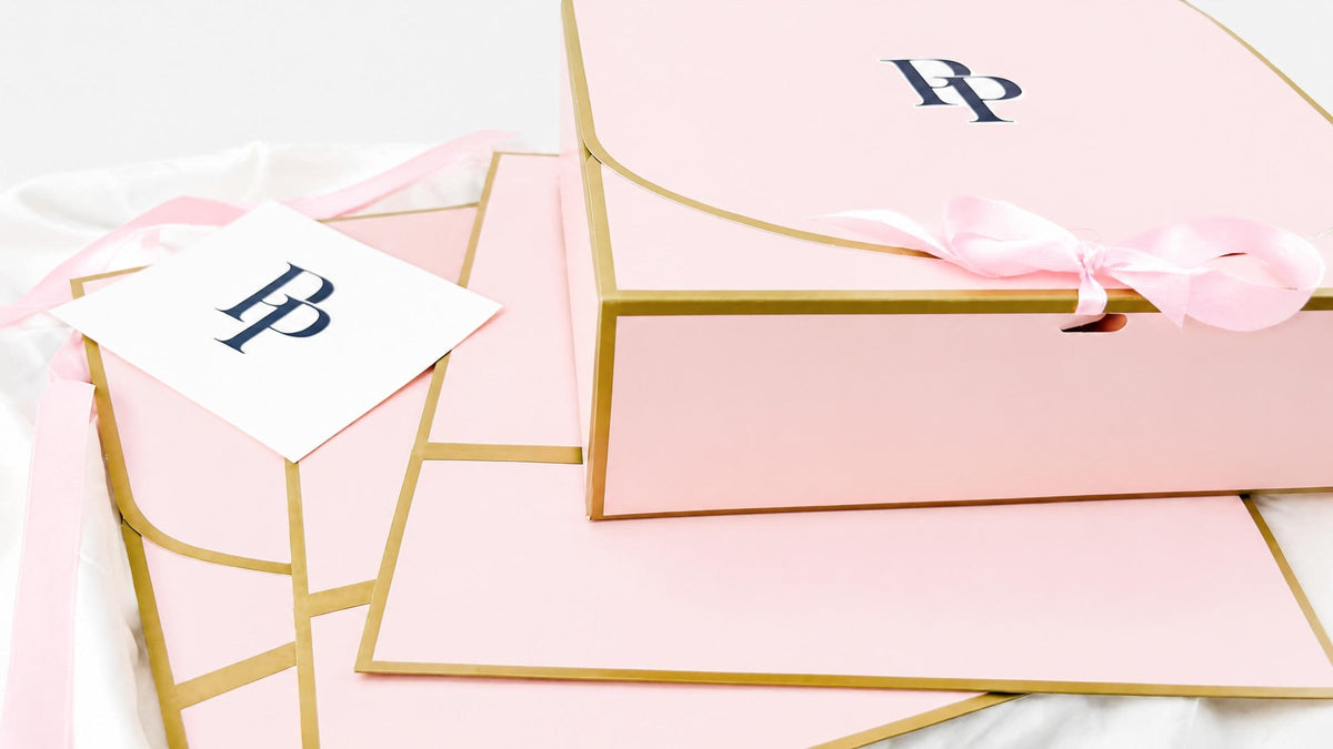 Stacked Public Prep Presents gift boxes with a card