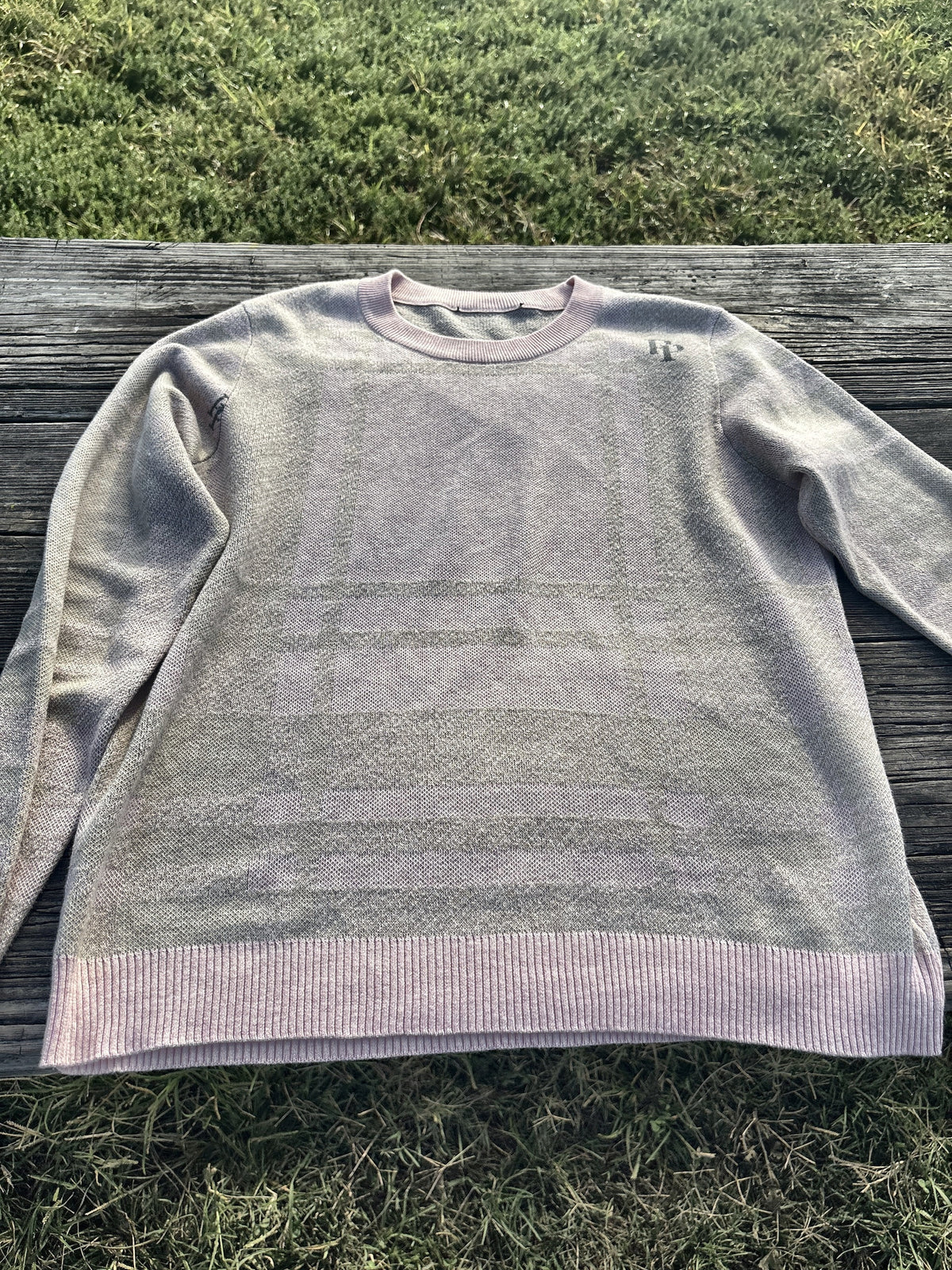 French Slate & Rose crewneck sweater laid flat outdoors, showing the tonal tartan and rose pink trim