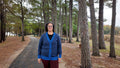 Navy and collegiate blue cardigan full length on a pine path