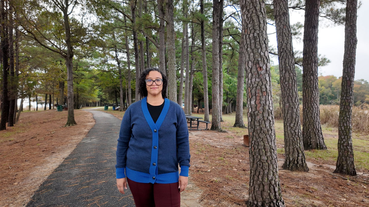 Navy and collegiate blue cardigan full length on a pine path