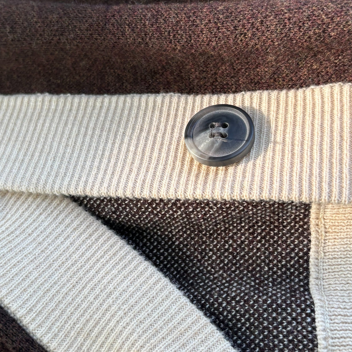 Square detail of Public Prep chocolate brown and cream cardigan showing ribbed trim and button