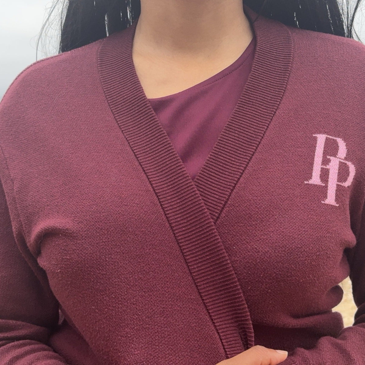 Burgundy and rose pink monogram cardigan close-up showing knit texture and PP monogram