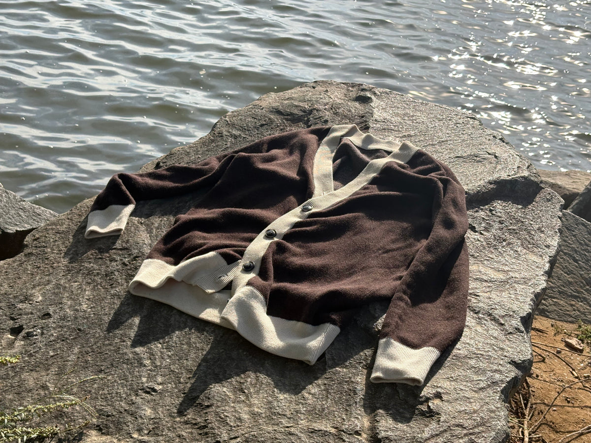 Brown & Cream cardigan on a rock by the water