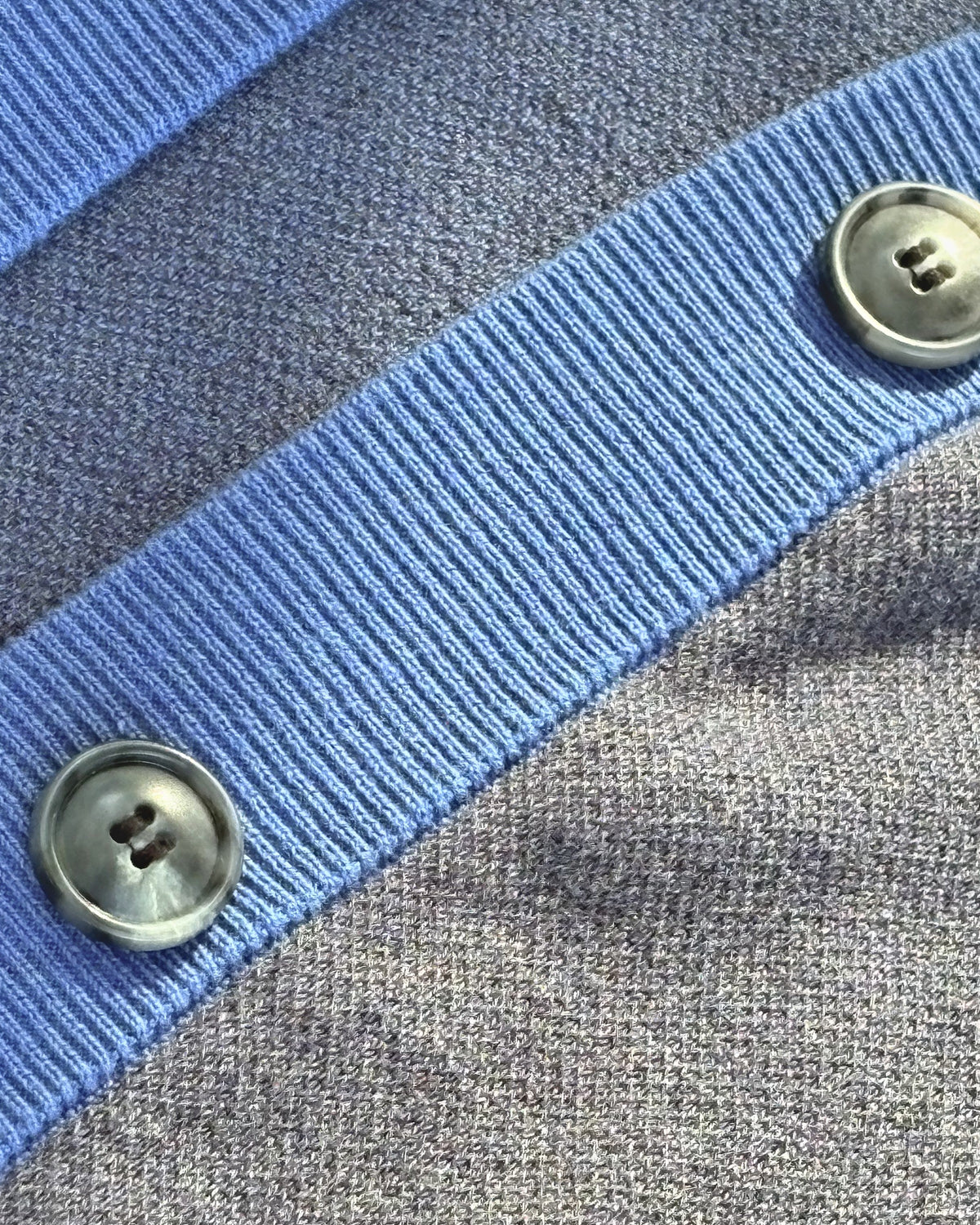 Horn-look buttons on the collegiate blue placket of the Public Prep Preppy Cardigan in Navy & Collegiate Blue