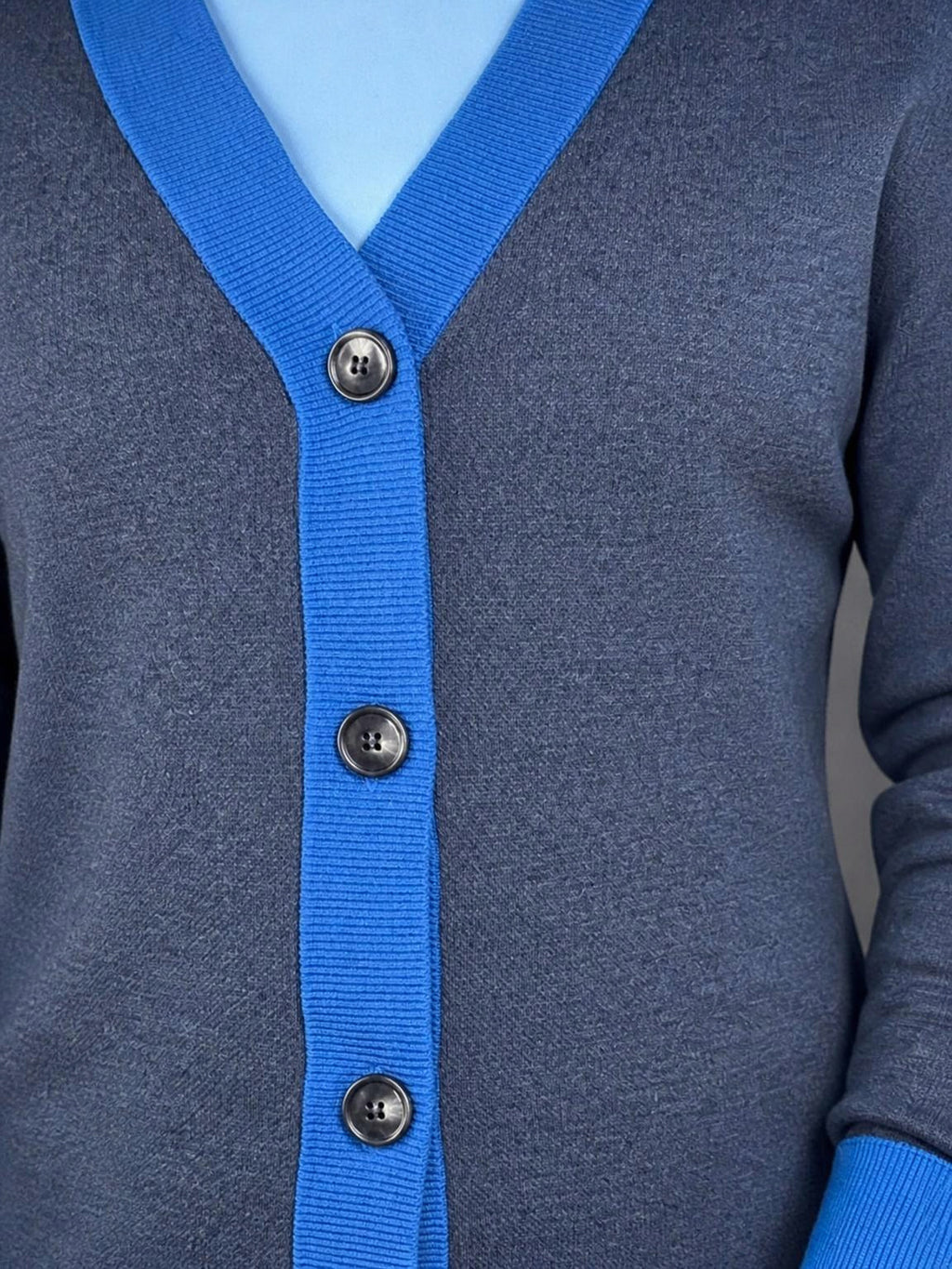 Collegiate blue button placket and horn-look buttons on the Public Prep Preppy Cardigan in Navy & Collegiate Blue