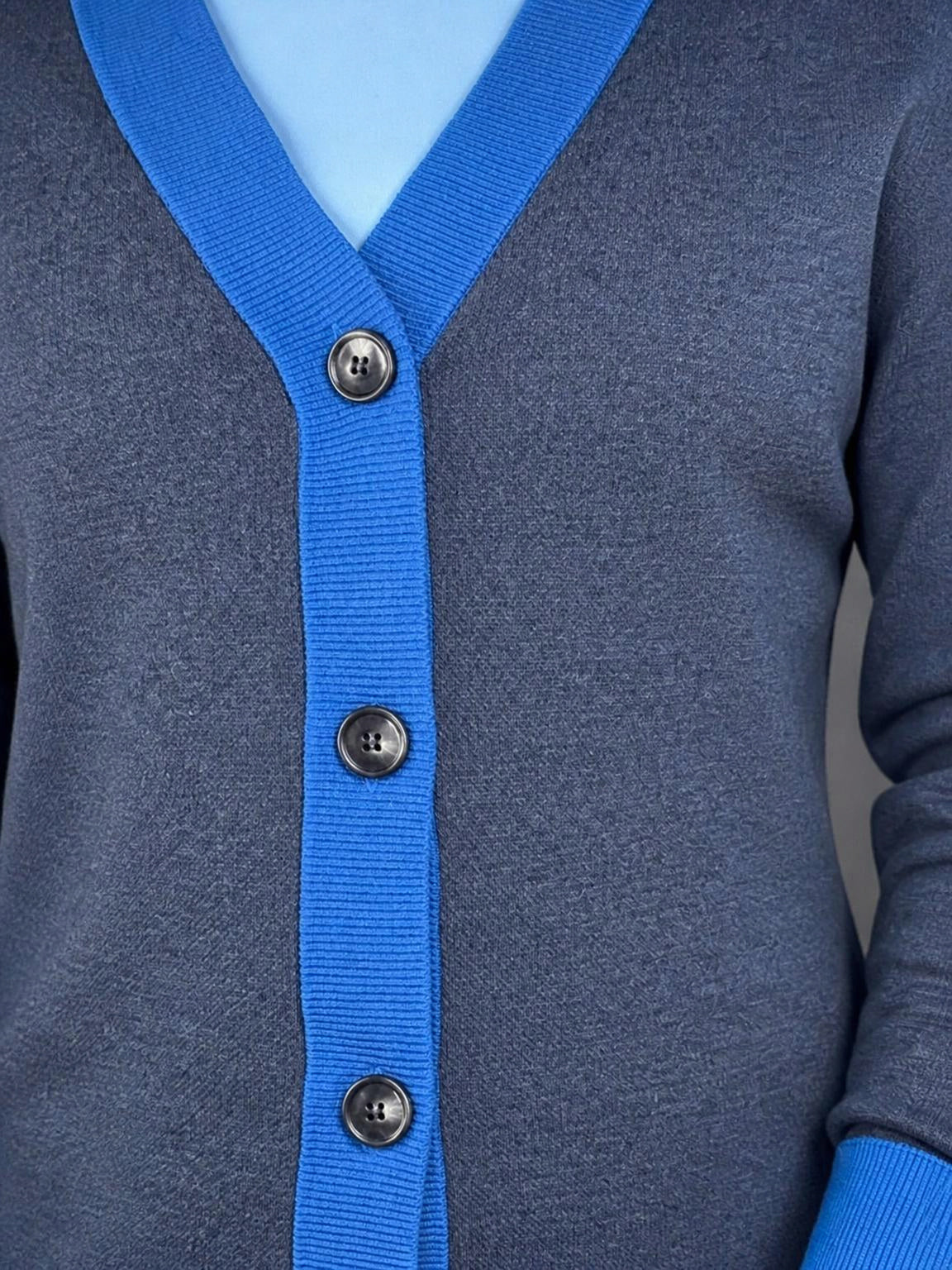 Collegiate blue button placket and horn-look buttons on the Public Prep Preppy Cardigan in Navy & Collegiate Blue