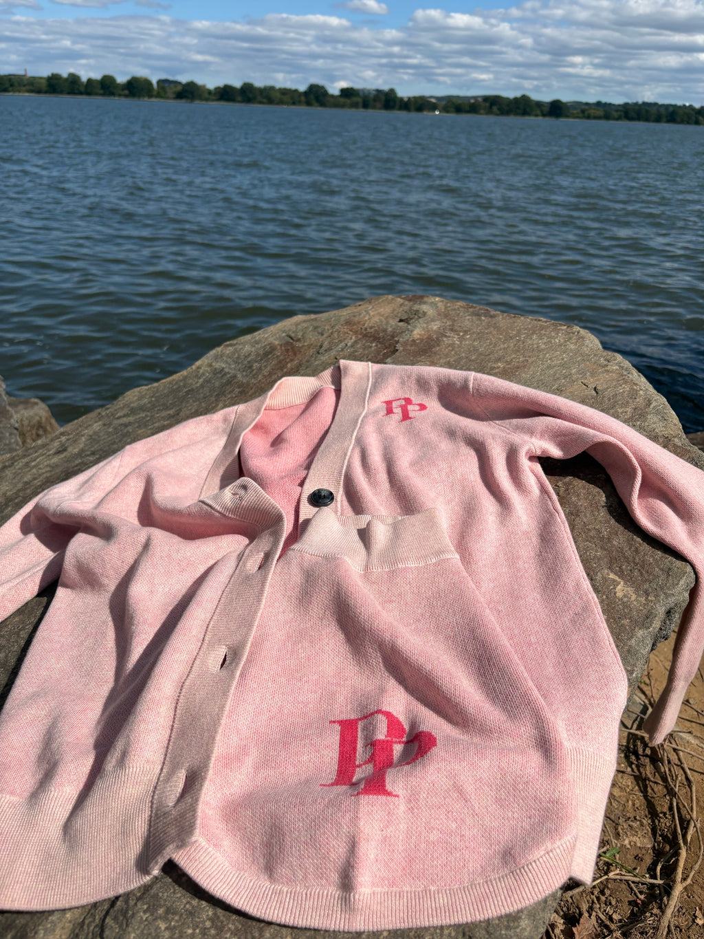 Pink monogram cardigan and matching pink monogram dog sweater by the lake