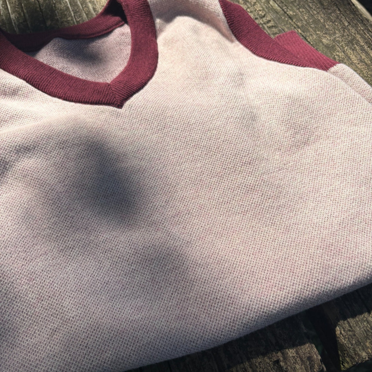 Public Prep Strawberry & Plum sweater vest shown in natural light with V-neck and contrast trim