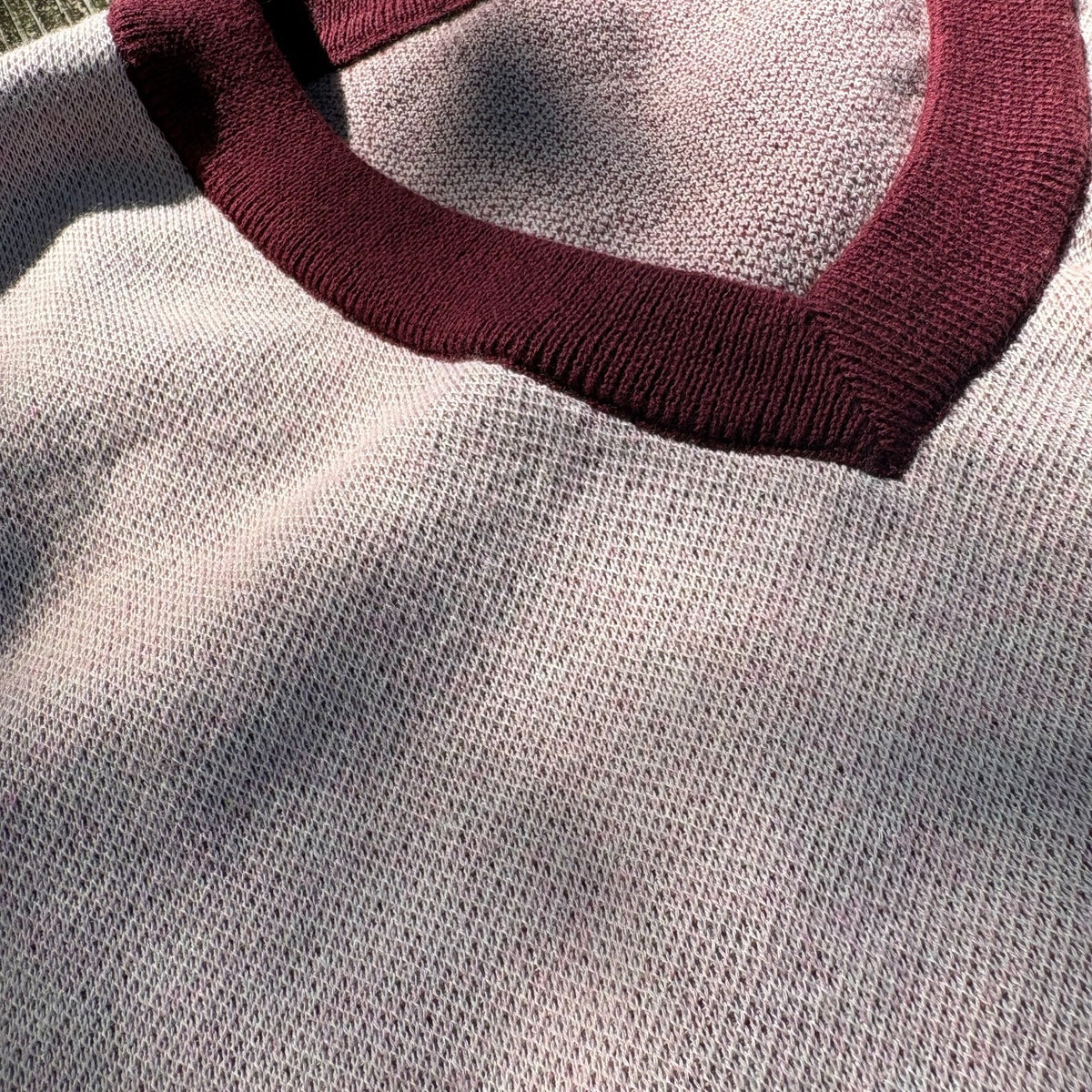 Close detail of Public Prep Strawberry & Plum sweater vest showing plum ribbed V-neck trim and knit texture