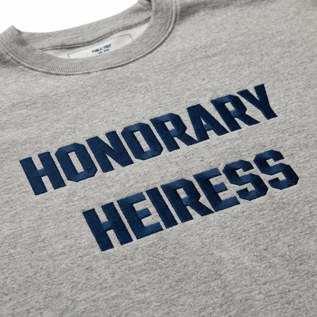 Close-up detail of the premium soft cotton fleece fabric on the Honorary Heiress crewneck sweatshirt