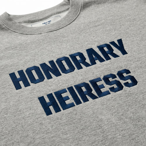 Close-up detail of the premium soft cotton fleece fabric on the Honorary Heiress crewneck sweatshirt