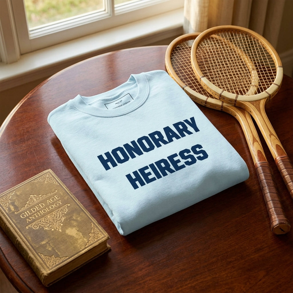 Honorary Heiress crewneck sweatshirt folded beautifully in a country club table setting