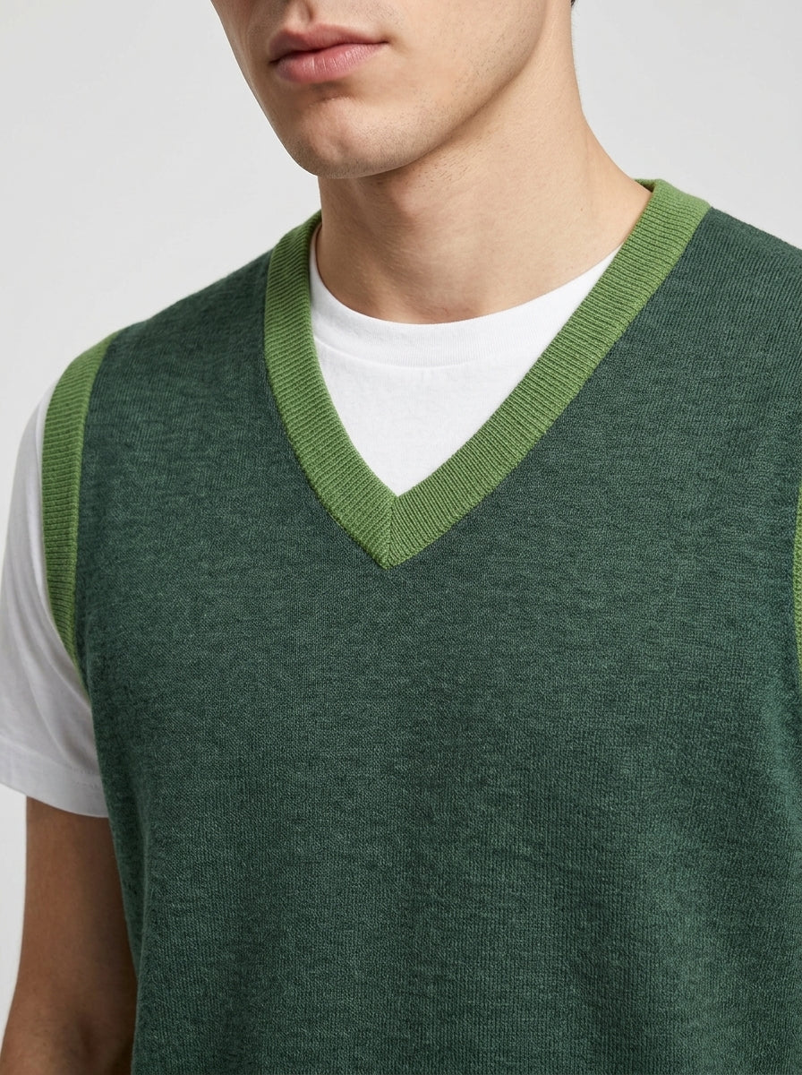Close-up torso detail shot of knit V-neck collar and contrast trim on model